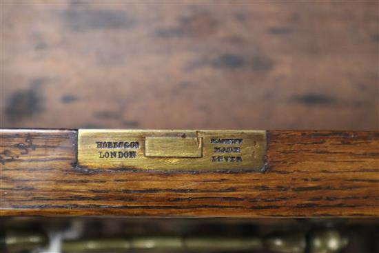 A late Victorian oak pedestal desk, bears Howard and Son stamp and plaque, together with a contemporary black W.150cm